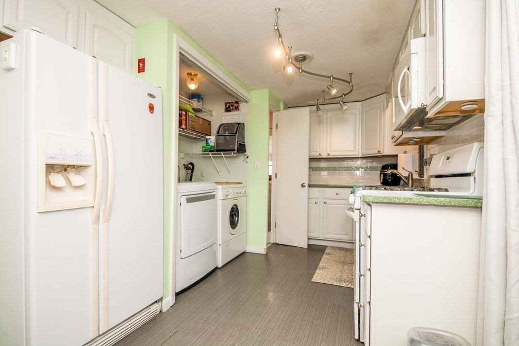 9 Grant Street Wareham, MA 02571 - Photo 9 of 18 a kitchen with white cabinets and white appliances