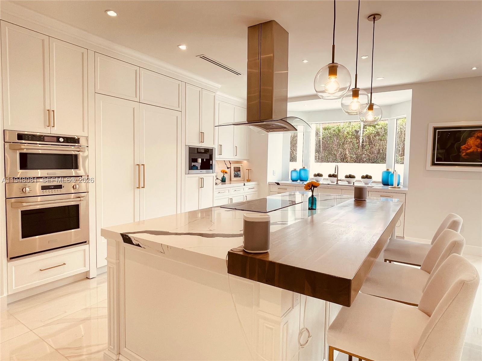 7233 Southwest 122 Place Miami, FL 33183 - Photo 17 of 78 a kitchen with stainless steel appliances kitchen island granite countertop a sink a stove and a refrigerator