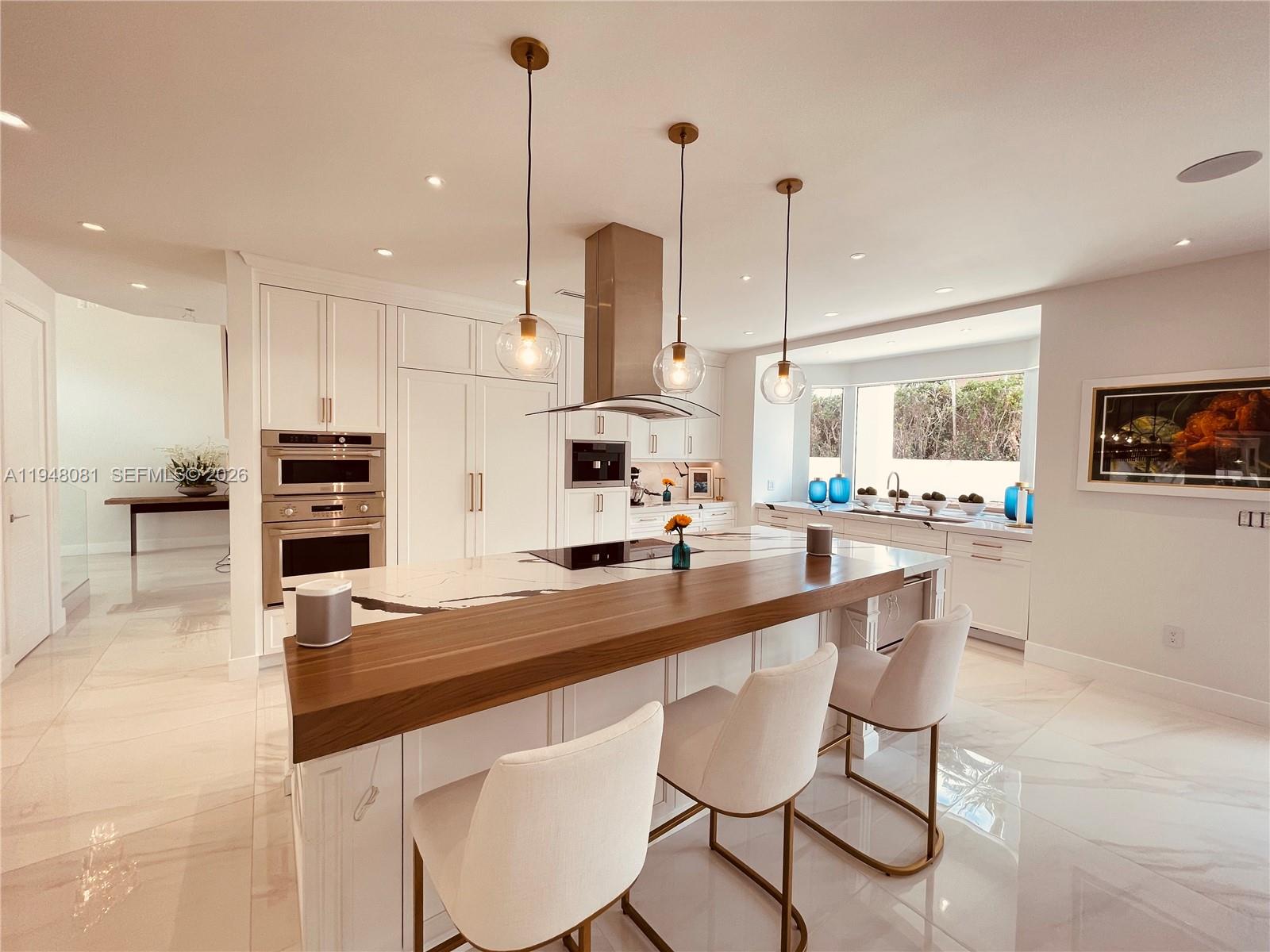 7233 Southwest 122 Place Miami, FL 33183 - Photo 18 of 58 a kitchen with stainless steel appliances kitchen island granite countertop a stove a sink and a wooden floors
