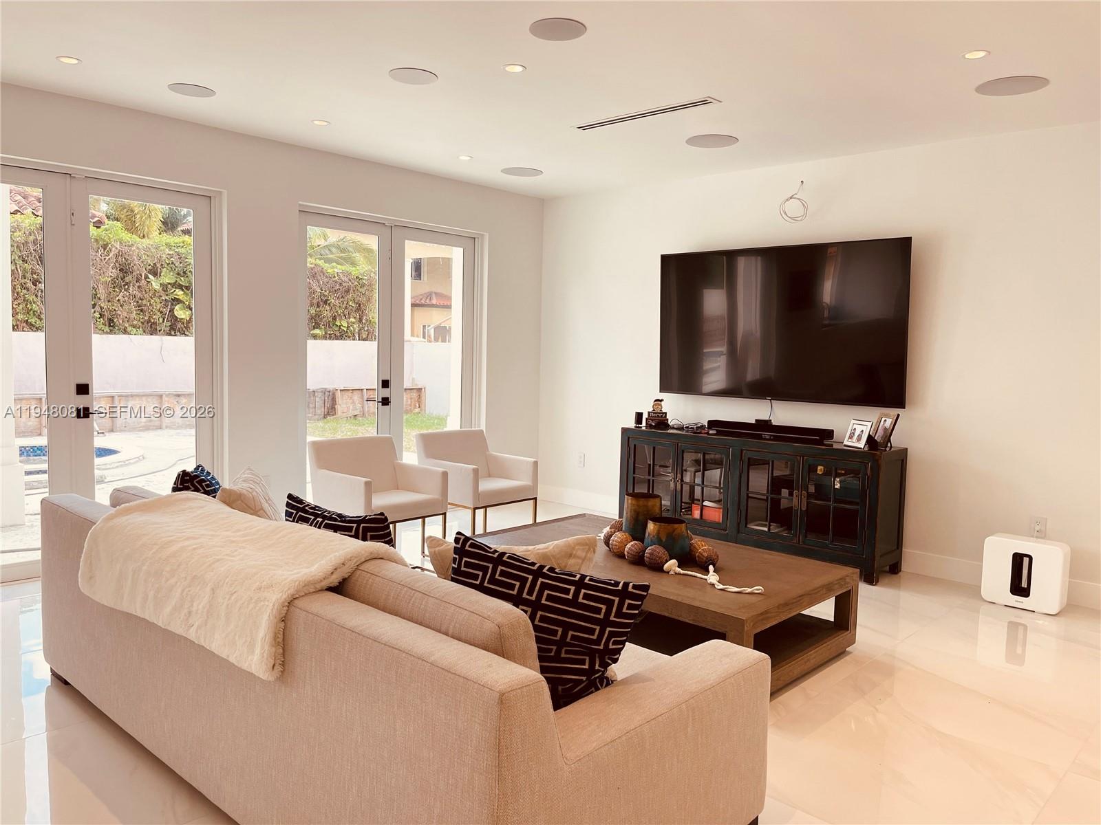 7233 Southwest 122 Place Miami, FL 33183 - Photo 27 of 78 a living room with furniture and a flat screen tv