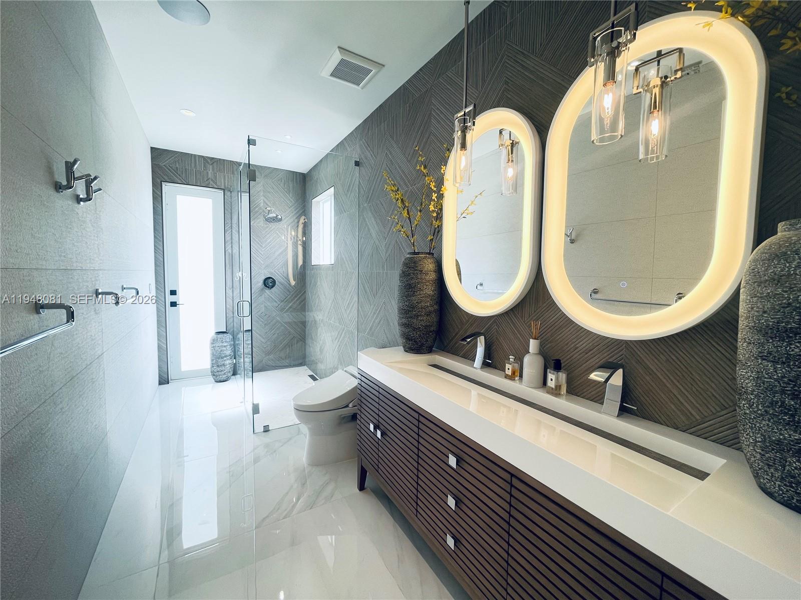 7233 Southwest 122 Place Miami, FL 33183 - Photo 30 of 58 a bathroom with a double vanity sink mirror and a toilet