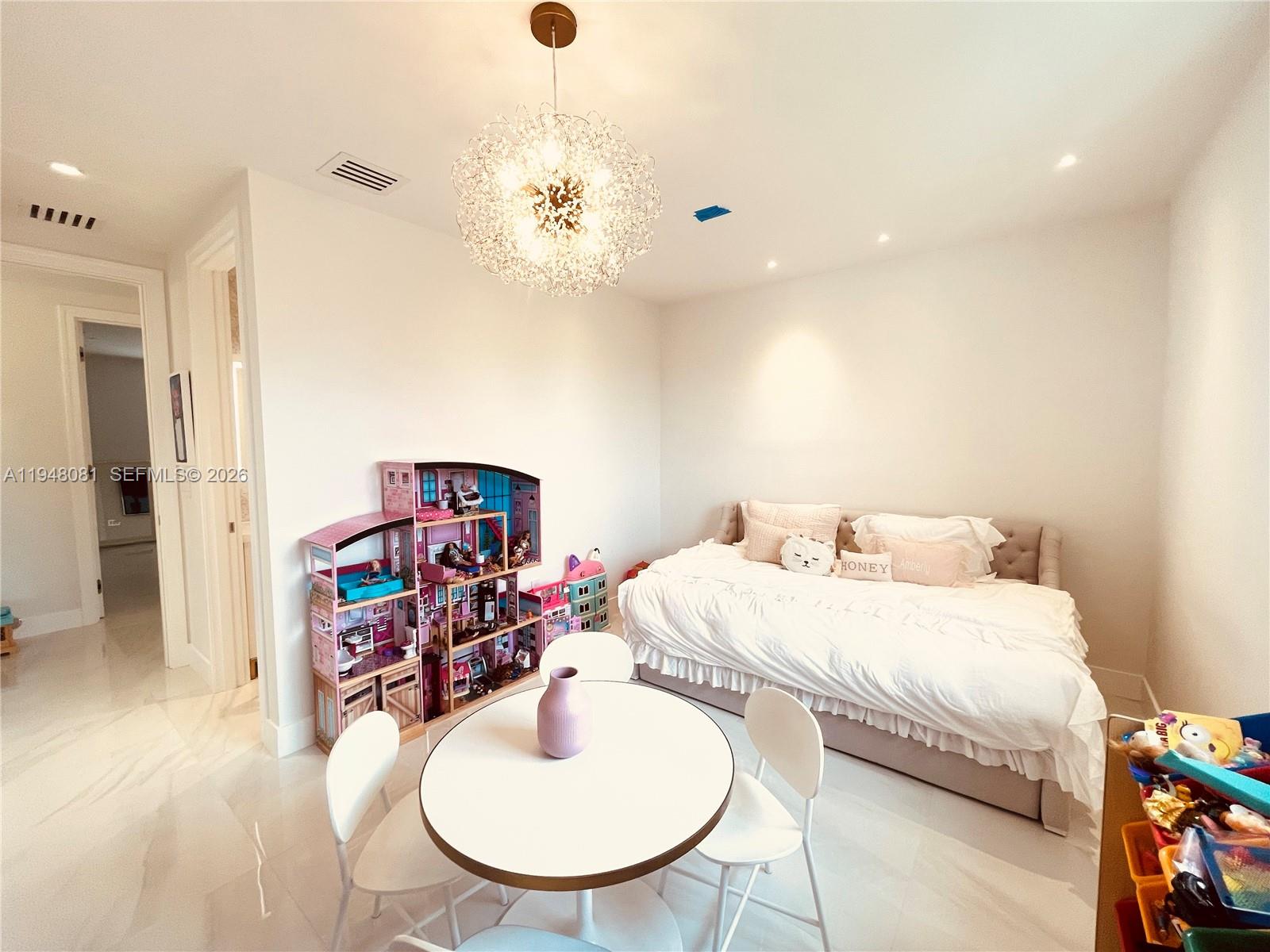 7233 Southwest 122 Place Miami, FL 33183 - Photo 45 of 78 a bedroom with a bed and a chandelier