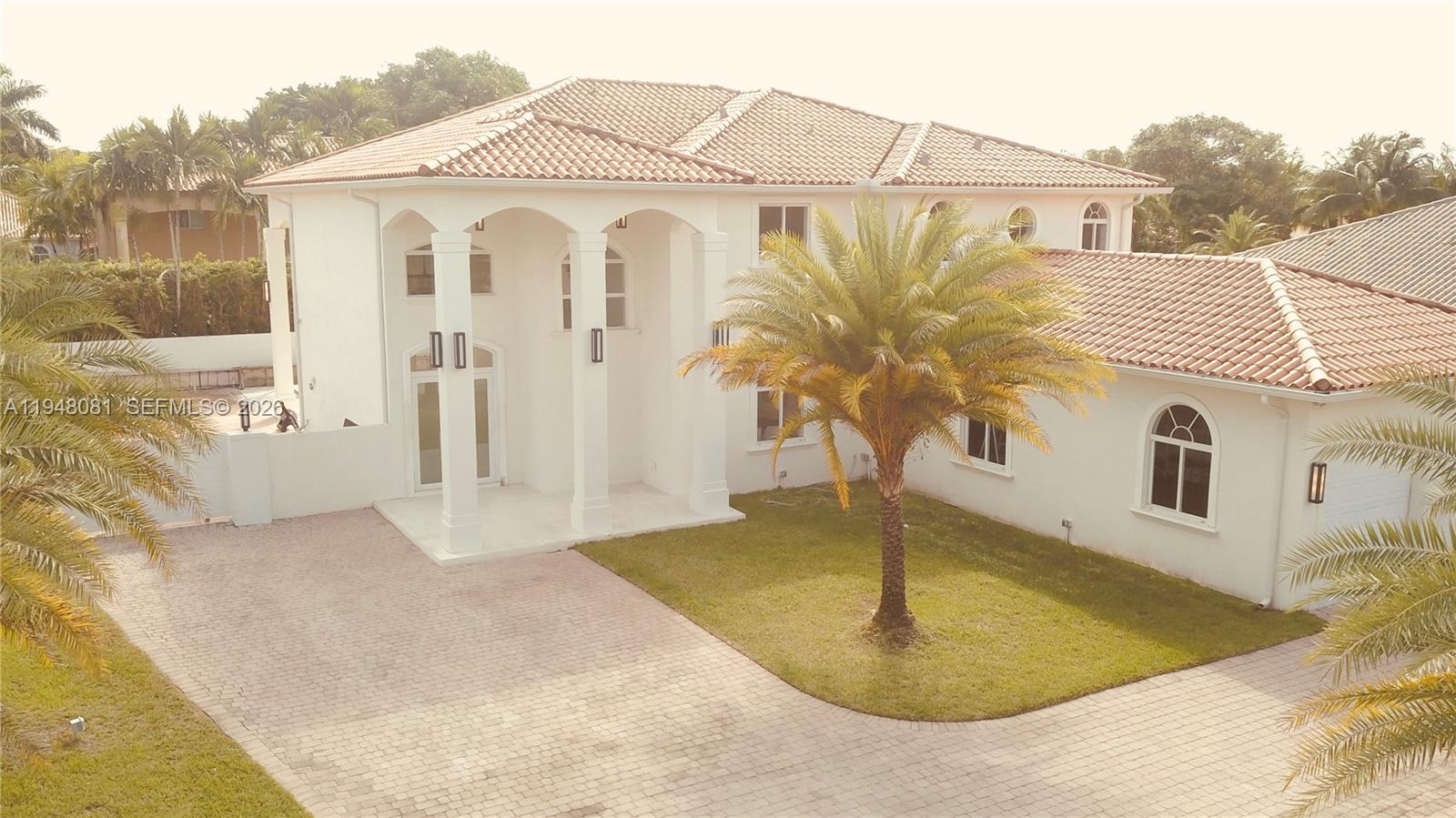 7233 Southwest 122 Place Miami, FL 33183 - Photo 5 of 78 a view of a white house with large windows
