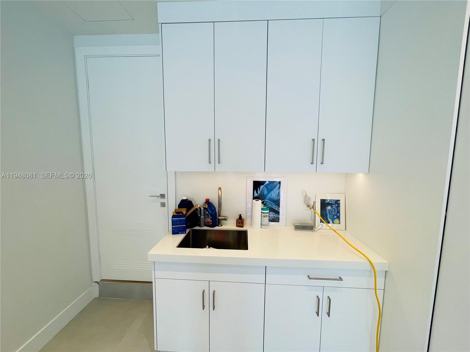 7233 Southwest 122 Place Miami, FL 33183 - Photo 55 of 58 a kitchen with a sink cabinets and a counter top