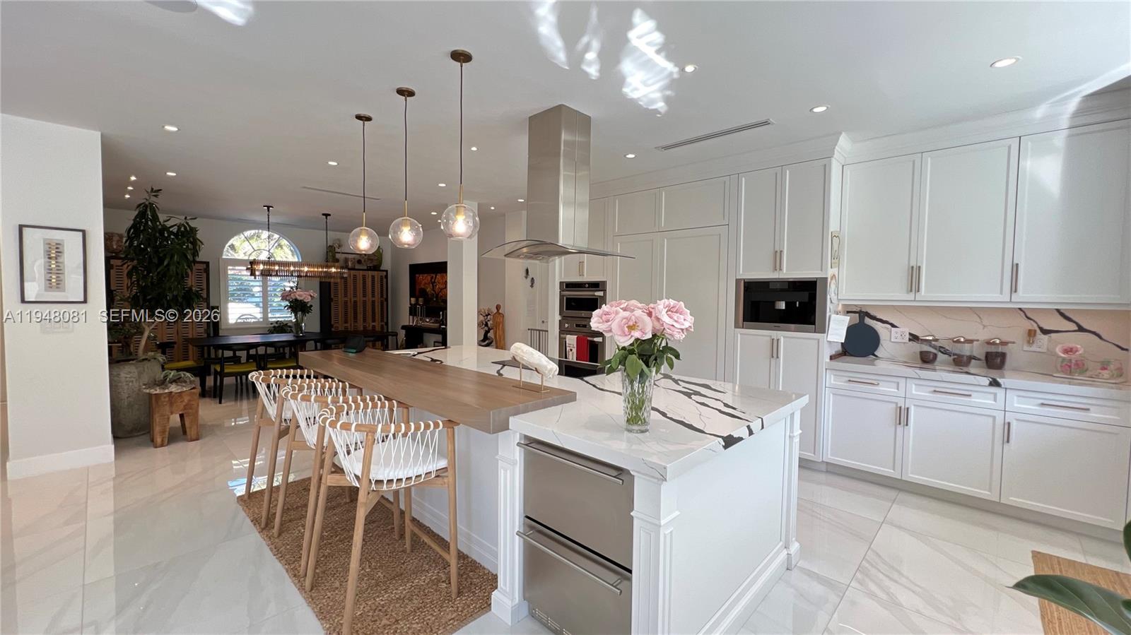 7233 Southwest 122 Place Miami, FL 33183 - Photo 74 of 78 a kitchen with kitchen island granite countertop a white cabinets and chairs