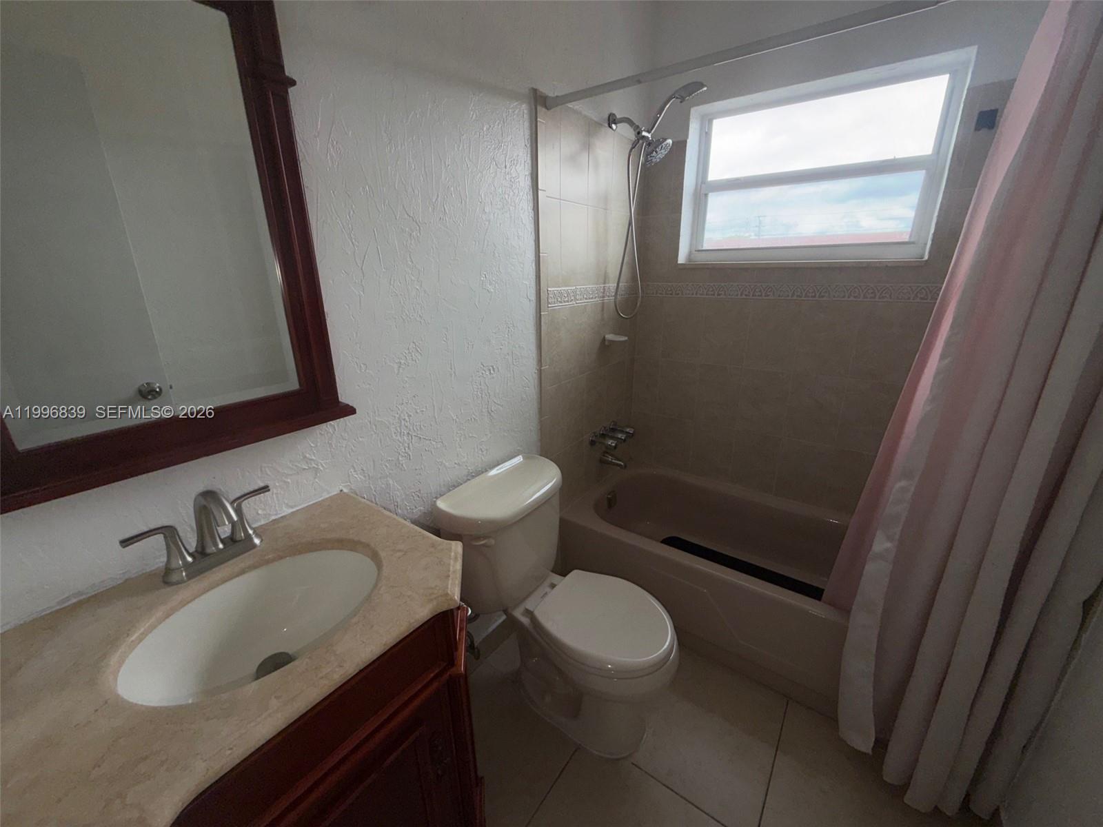 120 Royal Palm Road, Unit 301 Hialeah Gardens, FL 33016 - Photo 16 of 32 a bathroom with a sink toilet a mirror and shower