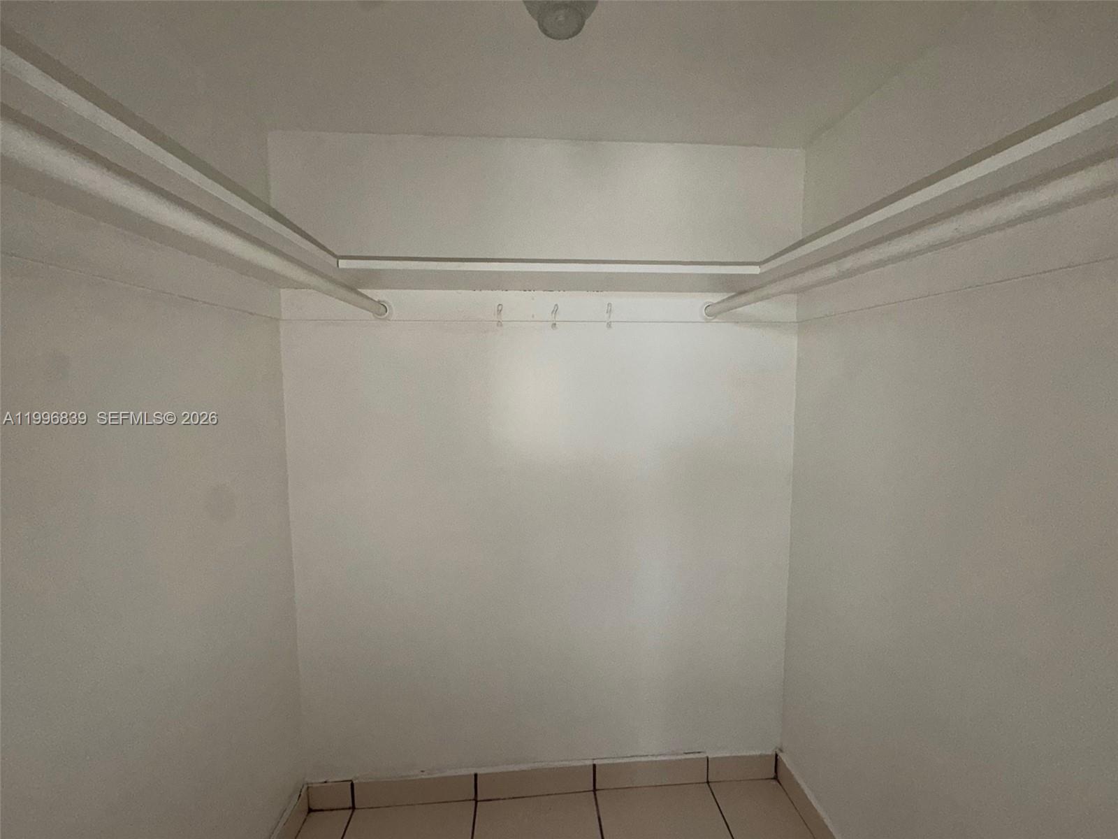 120 Royal Palm Road, Unit 301 Hialeah Gardens, FL 33016 - Photo 20 of 32 a view of a room with racks on the wall
