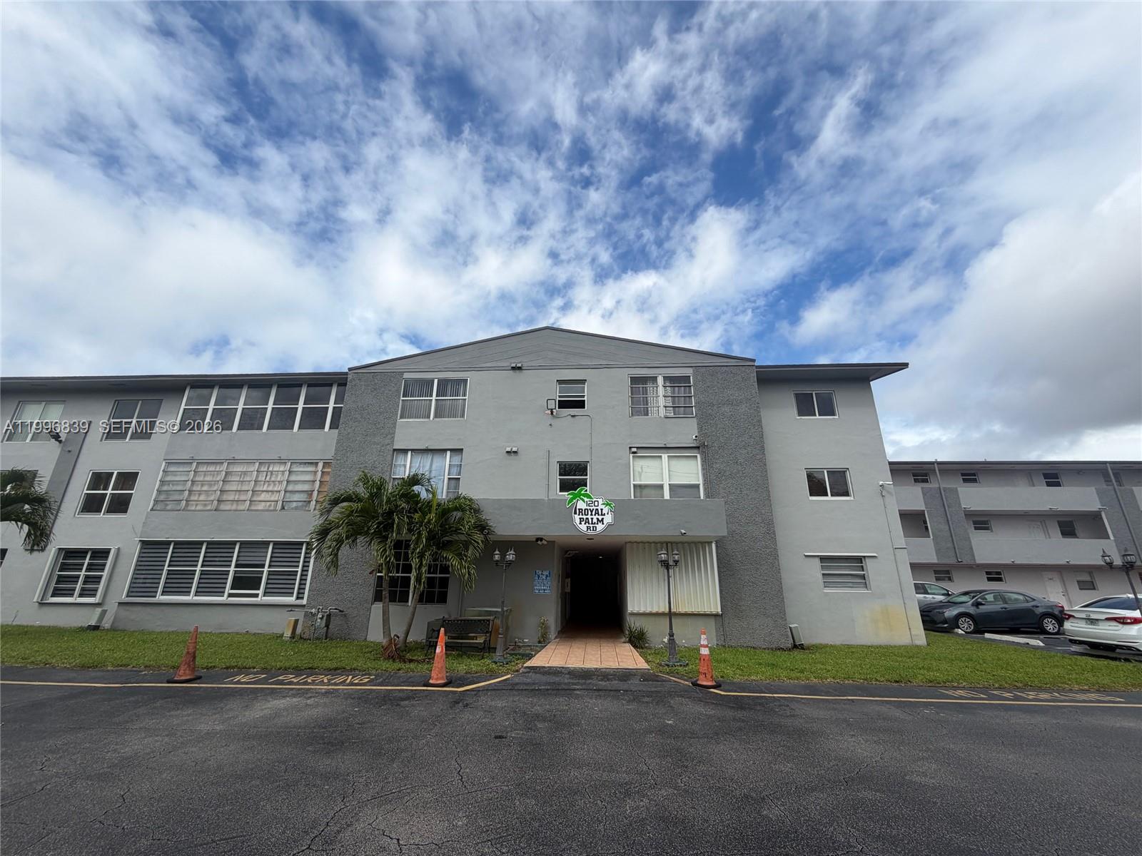 120 Royal Palm Road, Unit 301 Hialeah Gardens, FL 33016 - Photo 2 of 32 a front view of a building with garden