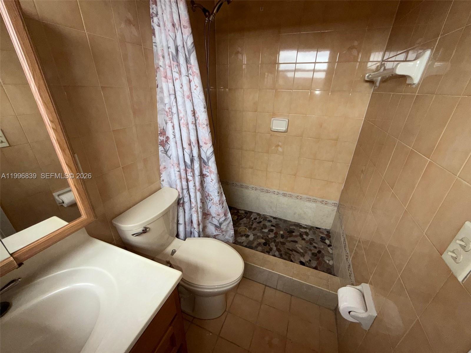 120 Royal Palm Road, Unit 301 Hialeah Gardens, FL 33016 - Photo 21 of 32 a bathroom with a sink toilet and shower