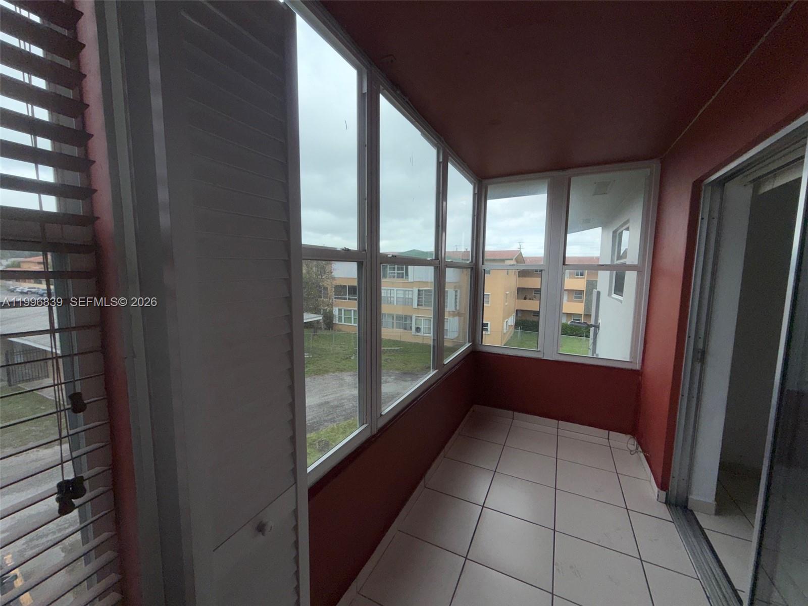 120 Royal Palm Road, Unit 301 Hialeah Gardens, FL 33016 - Photo 27 of 32 a view of an empty room and window