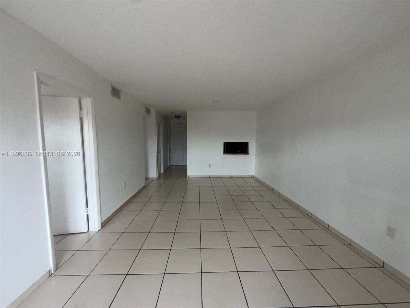 120 Royal Palm Road, Unit 301 Hialeah Gardens, FL 33016 - Photo 28 of 32 a view of an empty room and window