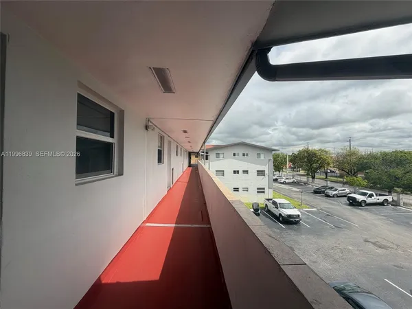an empty room with white walls and tiles