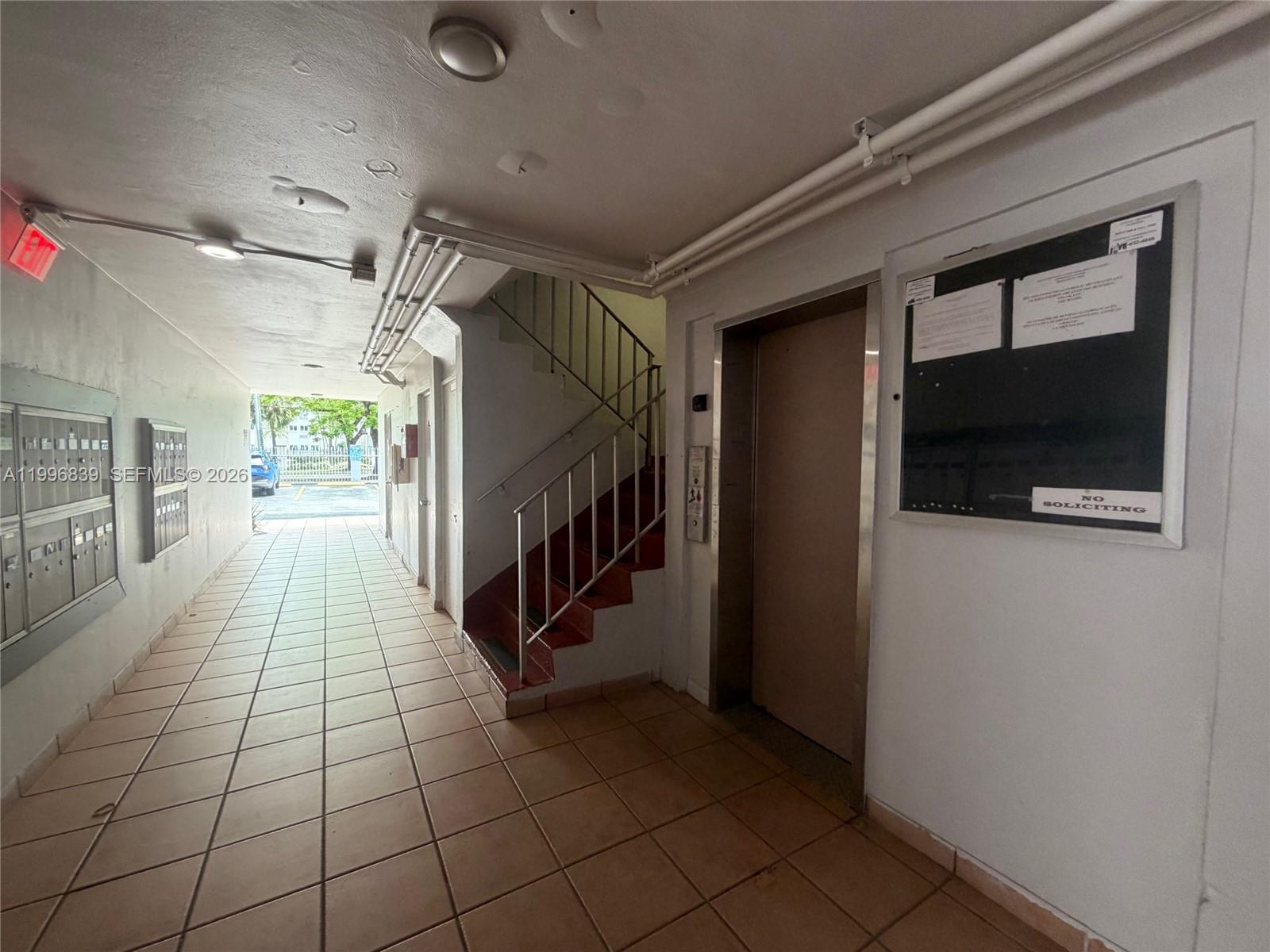 120 Royal Palm Road, Unit 301 Hialeah Gardens, FL 33016 - Photo 32 of 32 a hallway with a white stove and a refrigerator