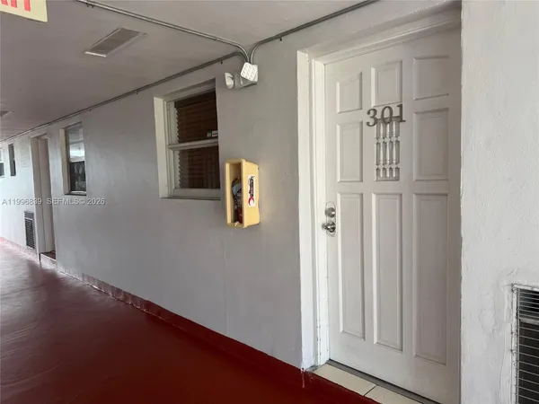 a kitchen with a refrigerator sink and cabinets