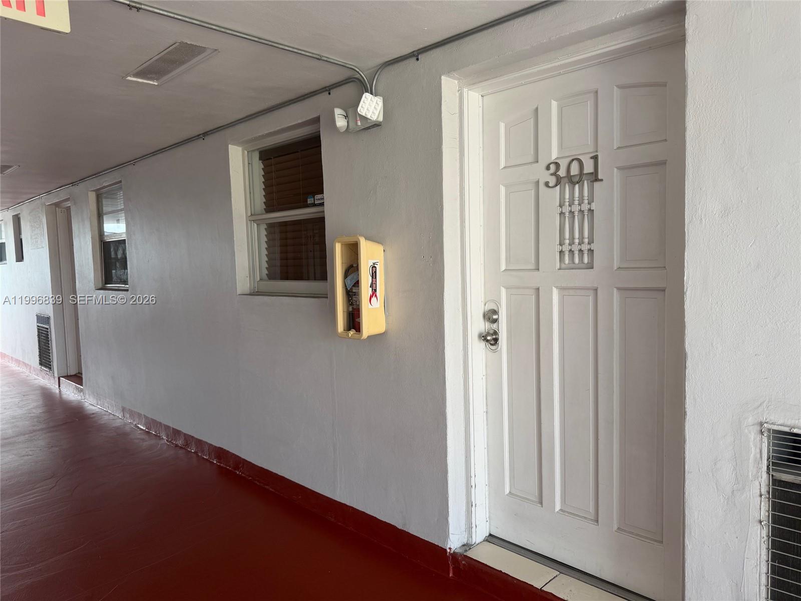 120 Royal Palm Road, Unit 301 Hialeah Gardens, FL 33016 - Photo 4 of 32 a view of a hallway with wooden floor and closet
