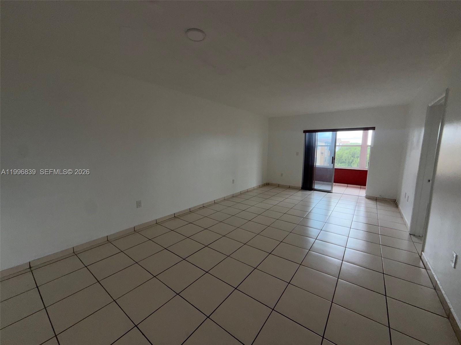 120 Royal Palm Road, Unit 301 Hialeah Gardens, FL 33016 - Photo 5 of 32 an empty room with windows