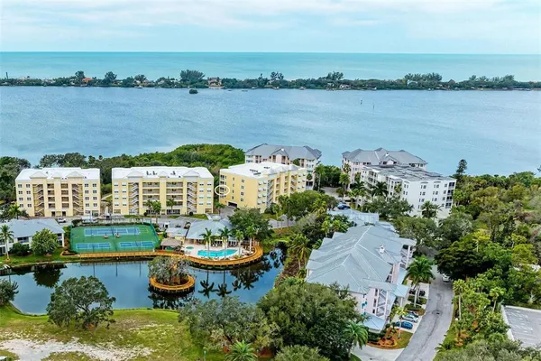 an aerial view of a house with outdoor space and lake view