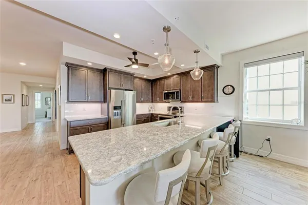 a kitchen with a refrigerator sink and microwave