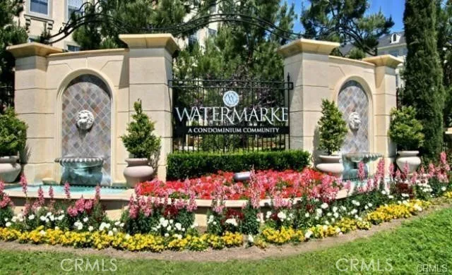 a front view of a house with a yard and fountain