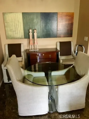 a view of two couches chair with a potted plant