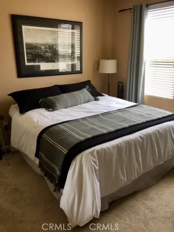 a bedroom with a bed and window