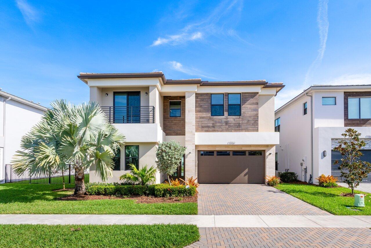 17056 Teton River Road Boca Raton, FL 33496 - Photo 1 of 76 a front view of a house with a garden and yard