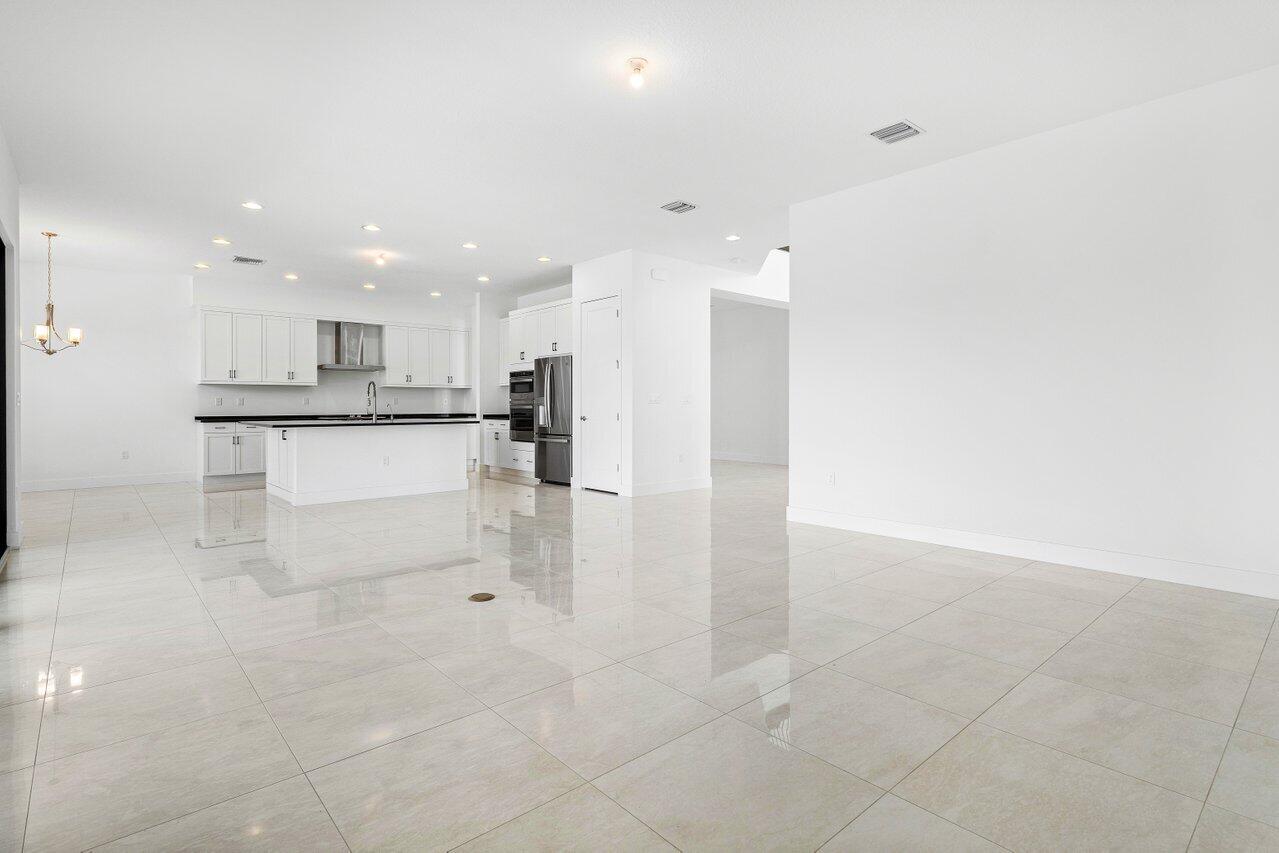 17056 Teton River Road Boca Raton, FL 33496 - Photo 19 of 76 a view of kitchen with stainless steel appliances a sink cabinets and a fireplace