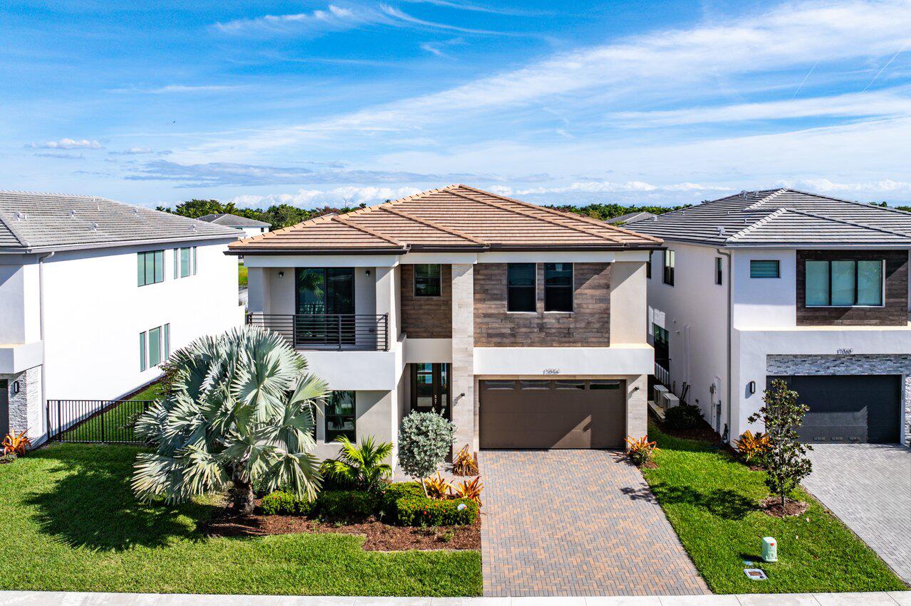 17056 Teton River Road Boca Raton, FL 33496 - Photo 4 of 76 a front view of a house with a garden