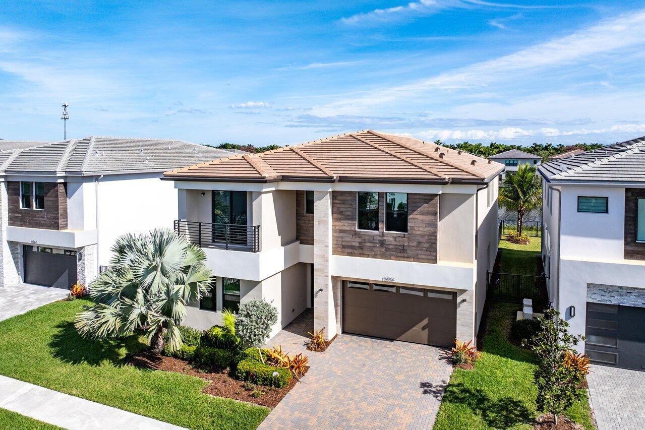 17056 Teton River Road Boca Raton, FL 33496 - Photo 47 of 76 a front view of a house with a garden