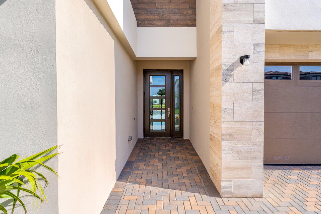 17056 Teton River Road Boca Raton, FL 33496 - Photo 7 of 76 a view of a hallway with wooden floor and a bathroom