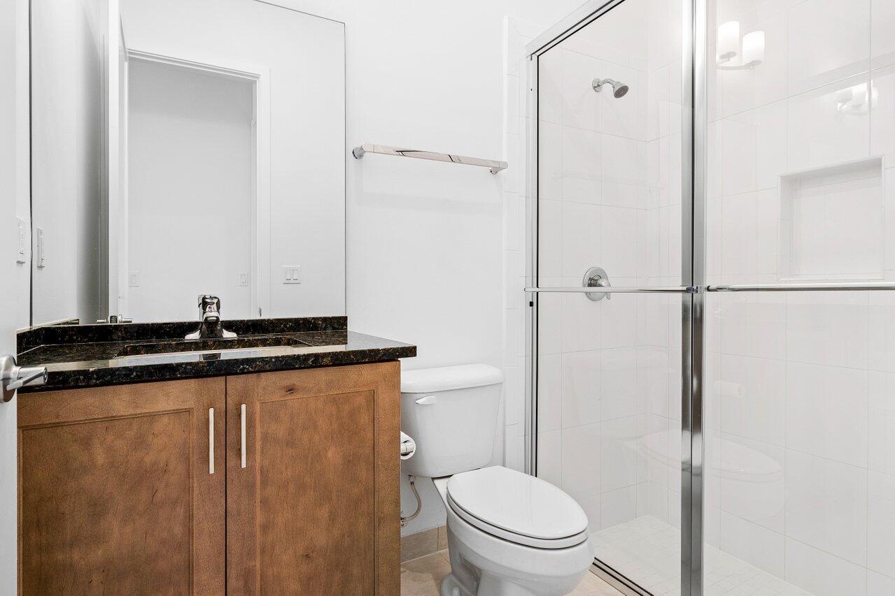 17056 Teton River Road Boca Raton, FL 33496 - Photo 10 of 76 a bathroom with a granite countertop sink mirror vanity and toilet