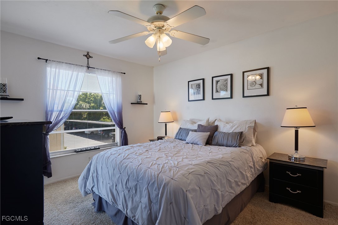 1100 Pondella Road, Unit 916 Cape Coral, FL 33909 - Photo 13 of 26 a bedroom with a bed and a window