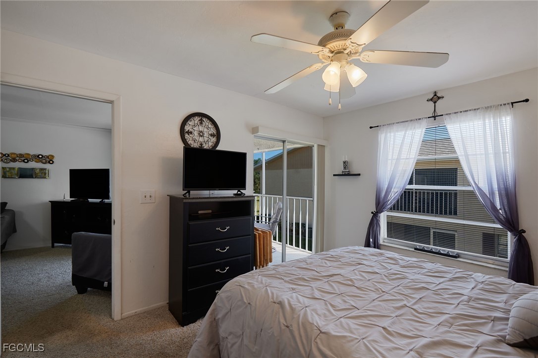 1100 Pondella Road, Unit 916 Cape Coral, FL 33909 - Photo 14 of 26 a bedroom with a large bed and a tv