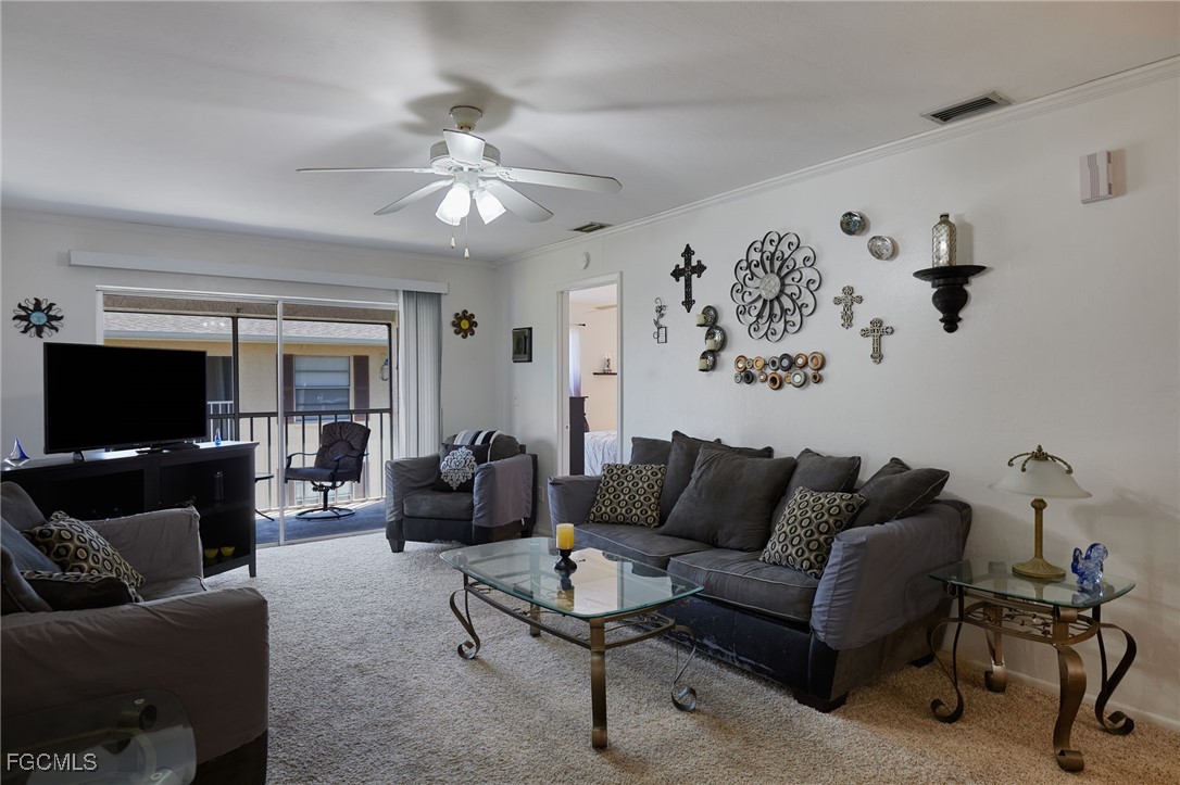 1100 Pondella Road, Unit 916 Cape Coral, FL 33909 - Photo 3 of 26 a living room with furniture and a flat screen tv