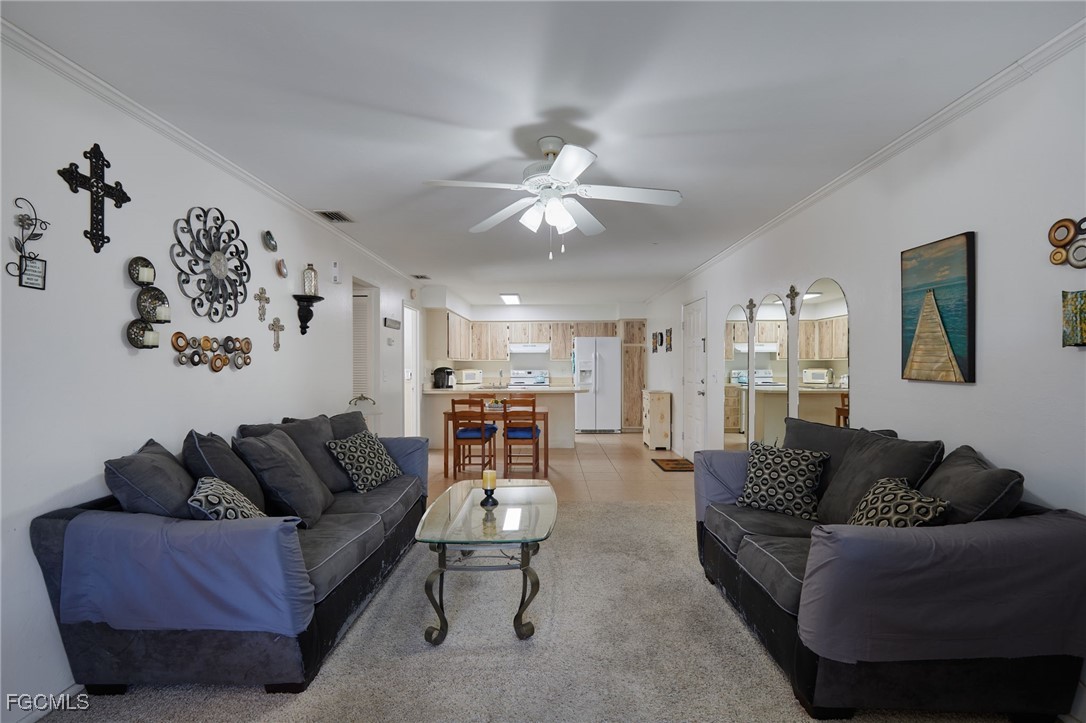 1100 Pondella Road, Unit 916 Cape Coral, FL 33909 - Photo 4 of 26 a living room with furniture and a chandelier