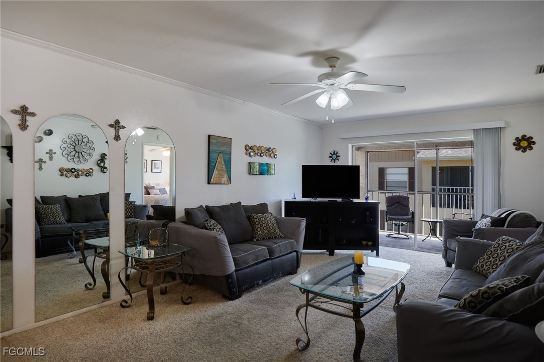 1100 Pondella Road, Unit 916 Cape Coral, FL 33909 - Photo 5 of 26 a living room with furniture and a flat screen tv