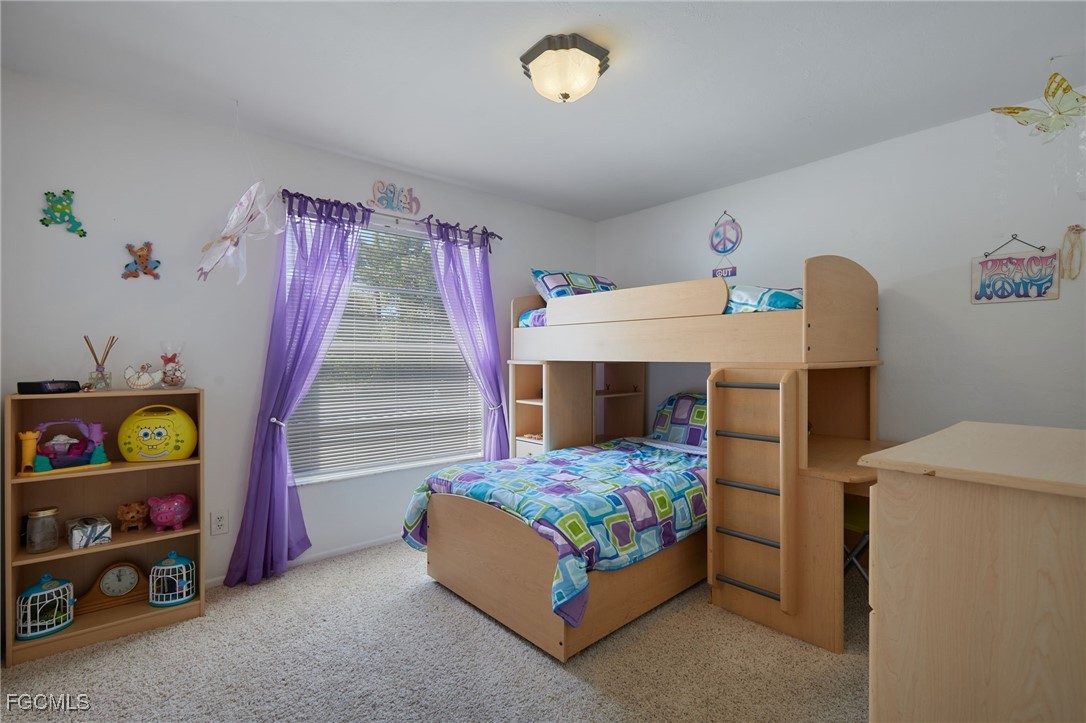 1100 Pondella Road, Unit 916 Cape Coral, FL 33909 - Photo 6 of 26 a bedroom with a bed and a window