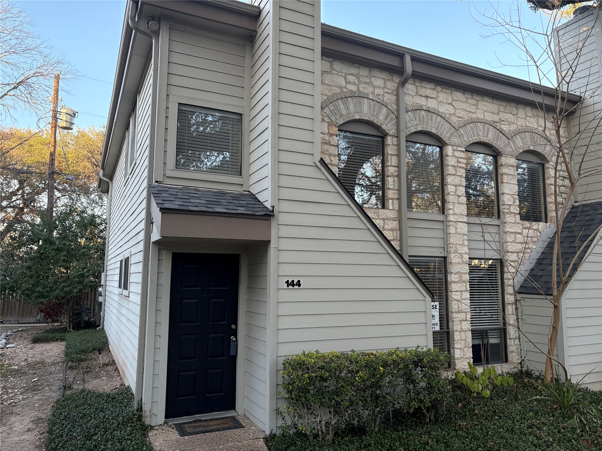 Entrance to property featuring stone siding and a chimney