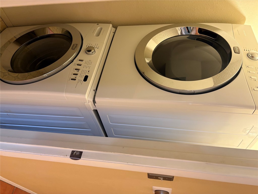 9226 Jollyville Road, Unit 144 Austin, TX 78759 - Photo 12 of 40 Laundry area featuring stacked washer and clothes dryer - in halway with a door to close off for privacy