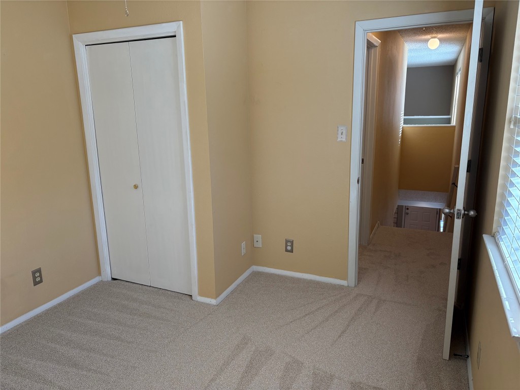 9226 Jollyville Road, Unit 144 Austin, TX 78759 - Photo 15 of 40 Unfurnished bedroom featuring carpet flooring and a closet