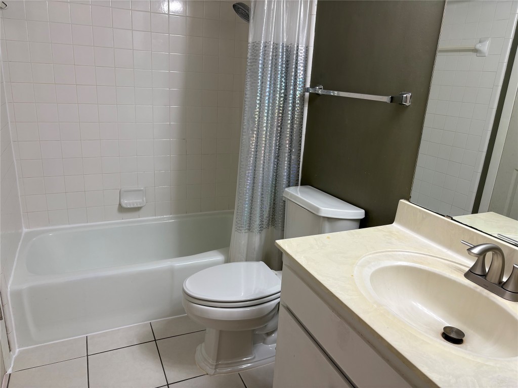 9226 Jollyville Road, Unit 144 Austin, TX 78759 - Photo 18 of 40 Bathroom featuring tile floors, vanity, and shower / bath combo with shower curtain