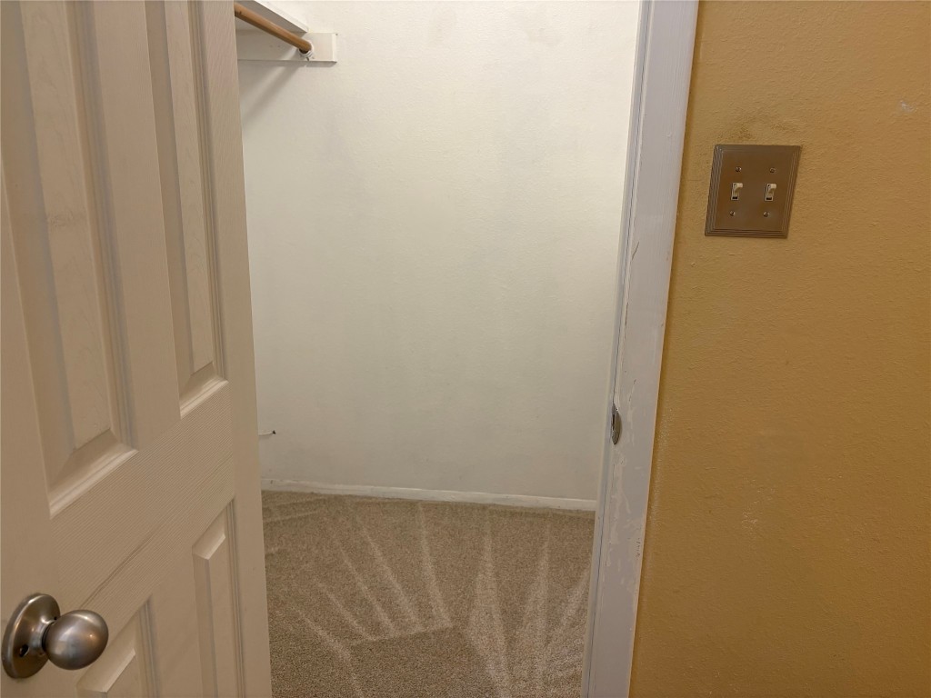 9226 Jollyville Road, Unit 144 Austin, TX 78759 - Photo 22 of 40 Walk in closet with light carpet - 3 separate rods for lots of hanging space