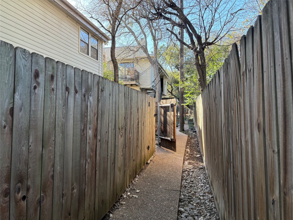 9226 Jollyville Road, Unit 144 Austin, TX 78759 - Photo 33 of 40 Back walkway to covered parking private spot through unit's backgate