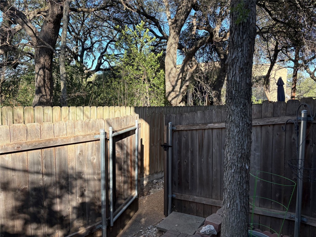 9226 Jollyville Road, Unit 144 Austin, TX 78759 - Photo 34 of 40 View of gate to walk way behind unit - going right to the assigned covered parking spot