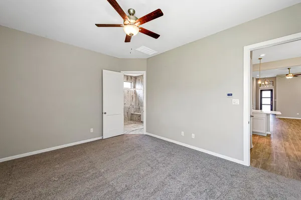 a spacious bedroom with a bed and a window