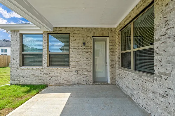 a view of an house with backyard space and a window