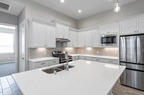 a kitchen that has a sink and a stove