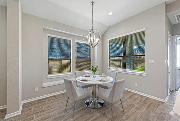 a kitchen with granite countertop a sink stainless steel appliances and white cabinets