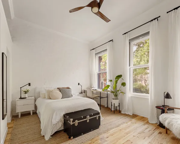 a bedroom with two beds and a flat screen tv