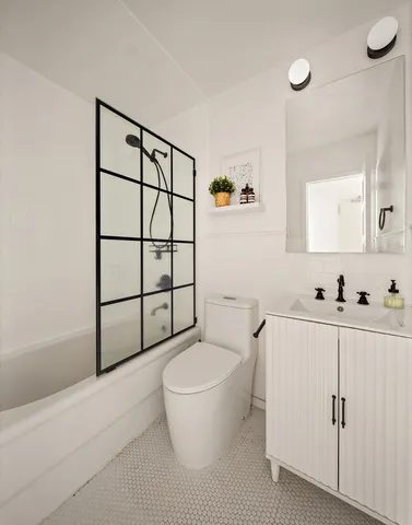 a spacious bedroom with a bed and a chandelier